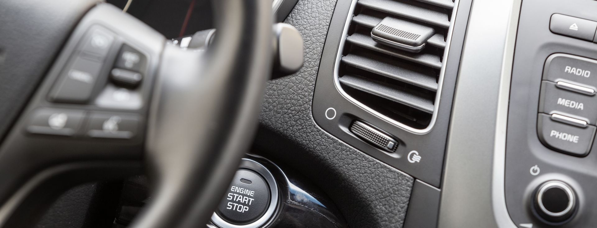 car interior with steering wheel, air conditioning and start button car interior with steering wheel, air conditioning and start button
