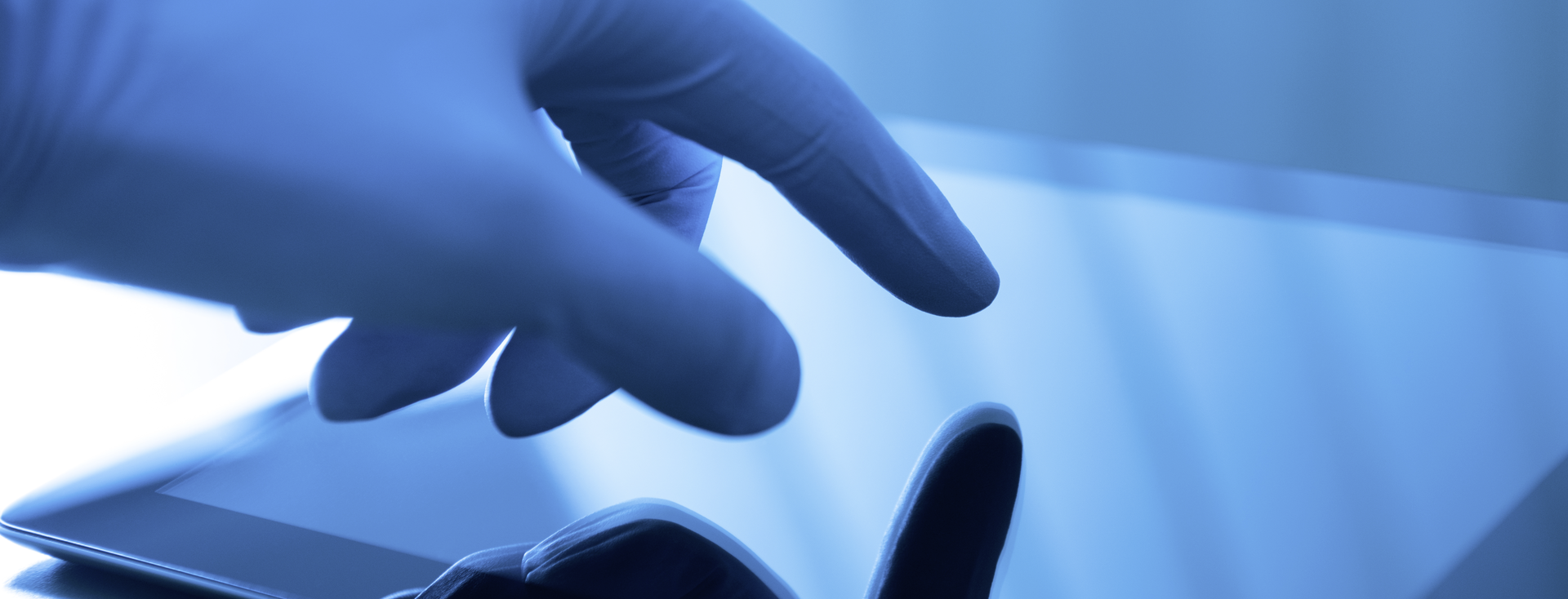 hand wearing a latex glove operates a touchscreen hand wearing a latex glove operates a touchscreen