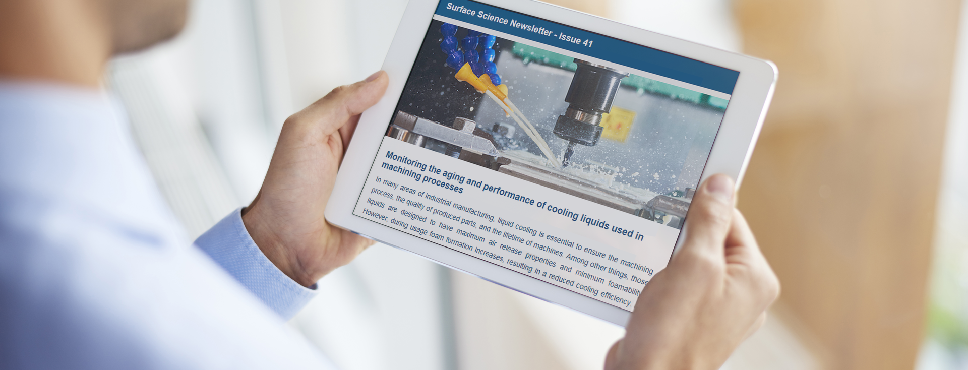 man reading a technical article about coolants in manufacturing on a tablet man reading a technical article about coolants in manufacturing on a tablet