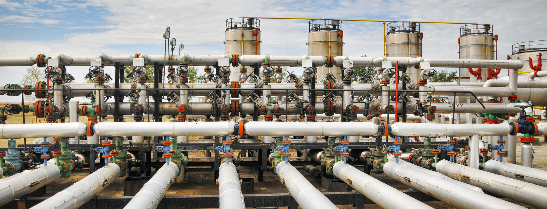 complex network of silver gas or oil pipelines and valves outdoors complex network of silver gas or oil pipelines and valves outdoors