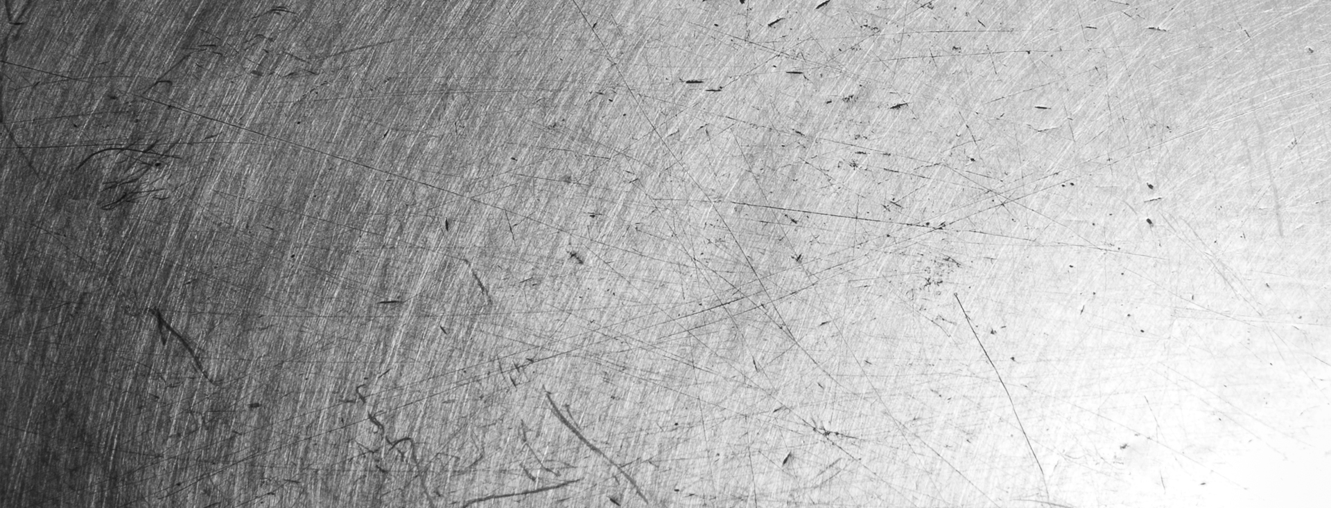 close-up of a scratched, brushed metal surface close-up of a scratched, brushed metal surface