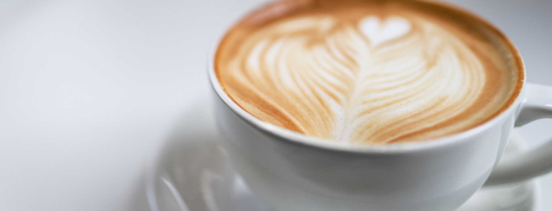 close-up of a cup of coffee with heart-shaped latte art close-up of a cup of coffee with heart-shaped latte art