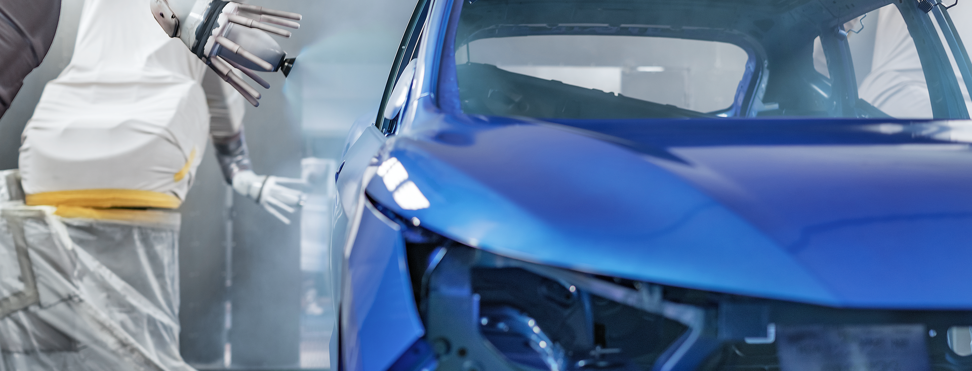 robotic arm paints the bodywork of a blue car robotic arm paints the bodywork of a blue car