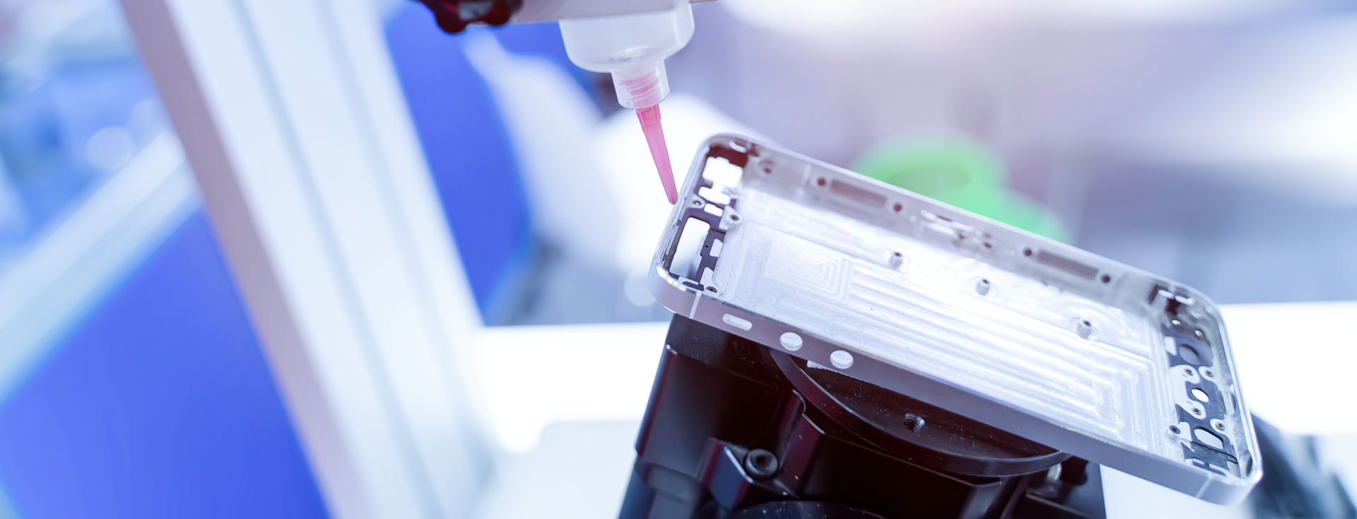 automatic dispensing system applies adhesive to a cell phone frame automatic dispensing system applies adhesive to a cell phone frame