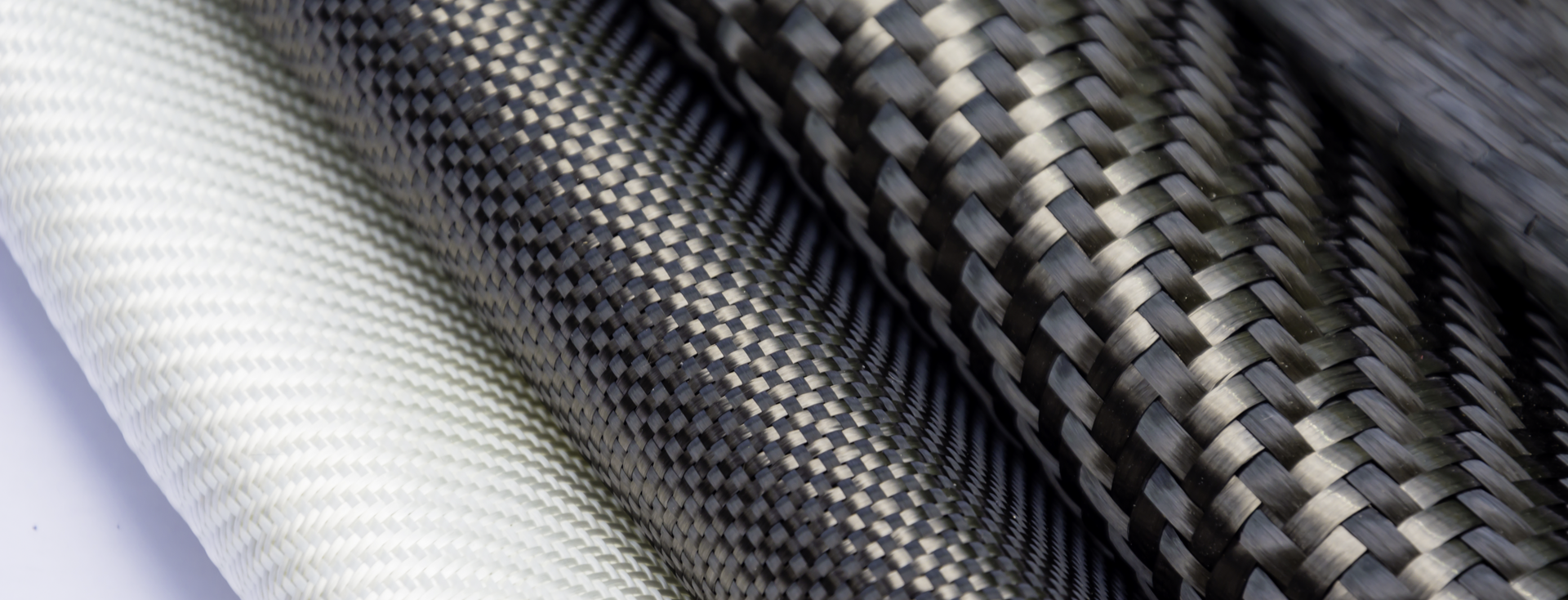 close-up of white, gray, and black carbon fibers close-up of white, gray, and black carbon fibers