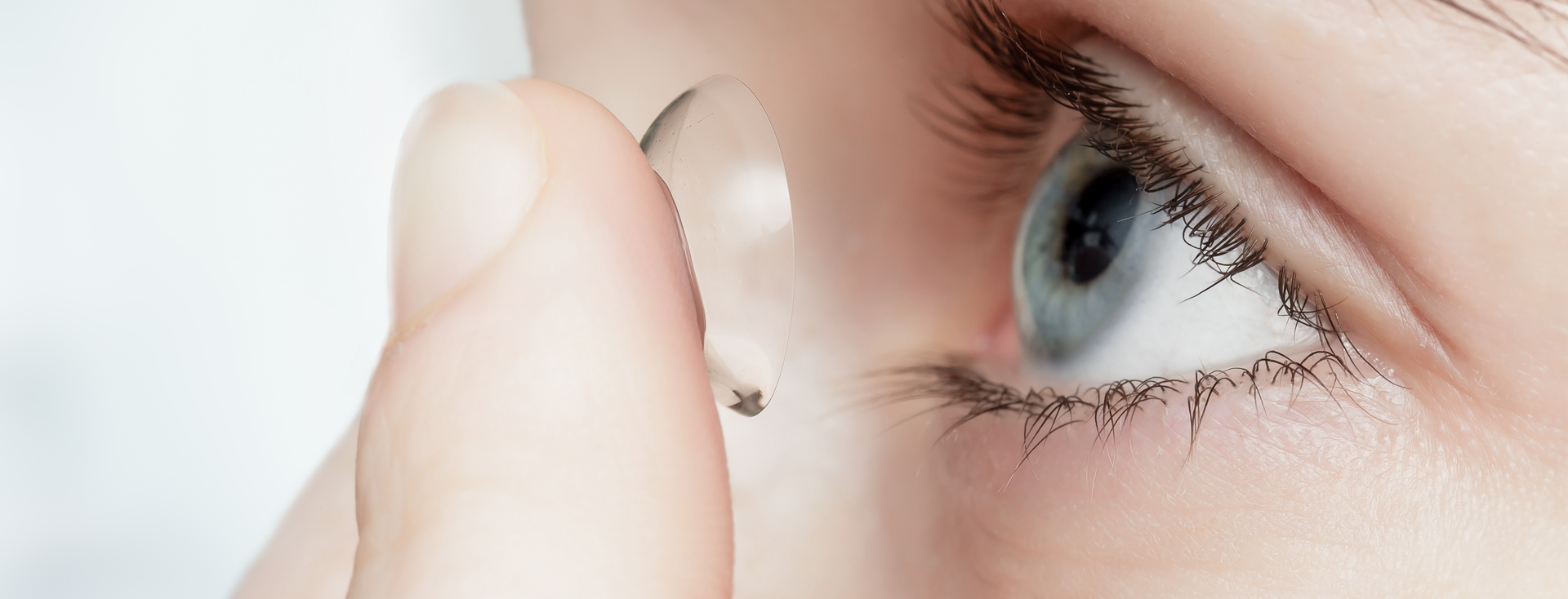 close-up of a person putting in a contact lens close-up of a person putting in a contact lens