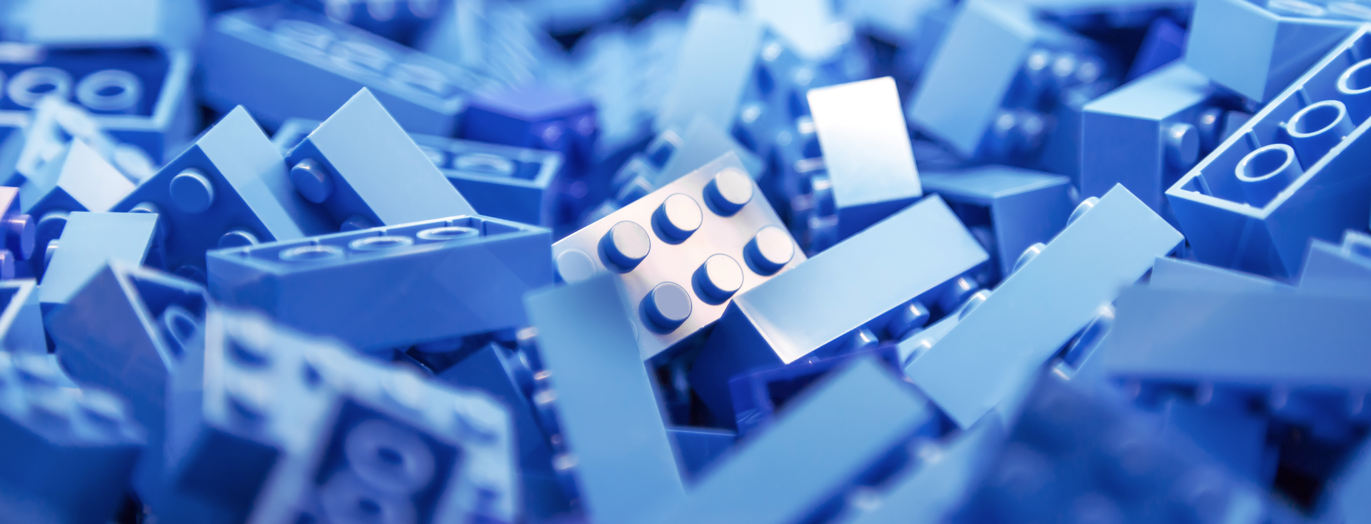 large pile of light blue plastic building blocks for children
