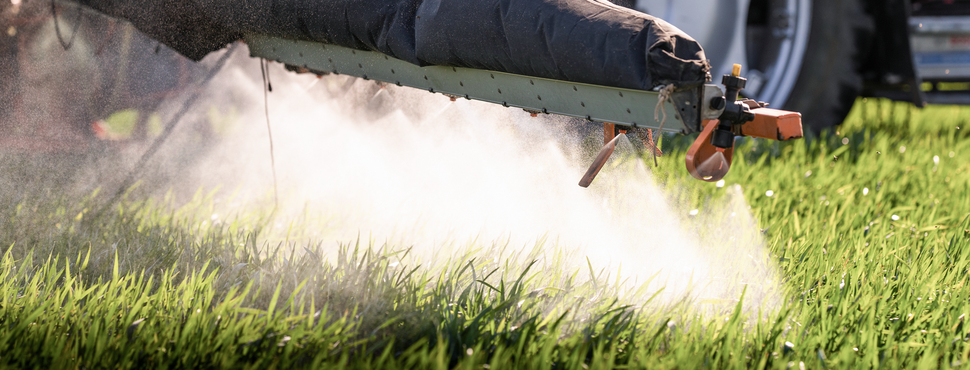 close-up of a tractor spraying a meadow with pesticides close-up of a tractor spraying a meadow with pesticides