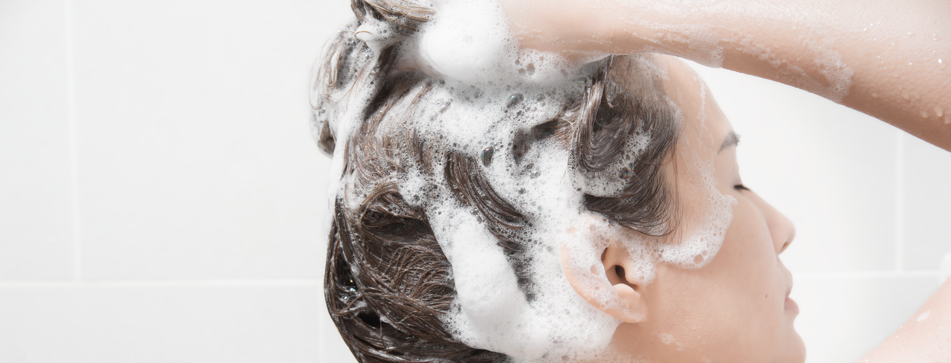 woman lathering and washing her hair