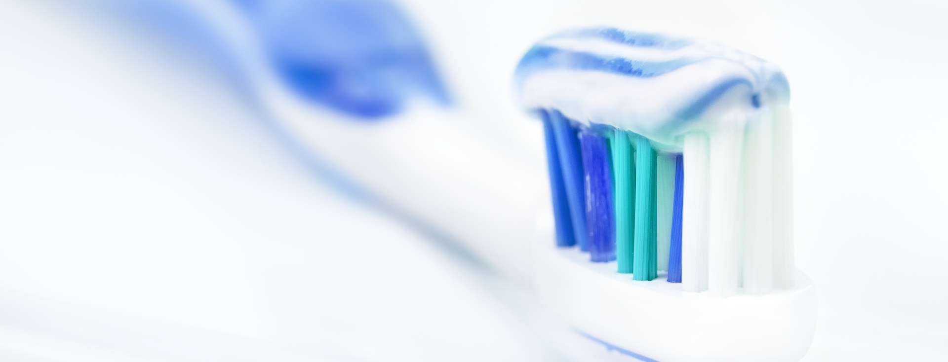 blue and white toothpaste on a blue and white toothbrush