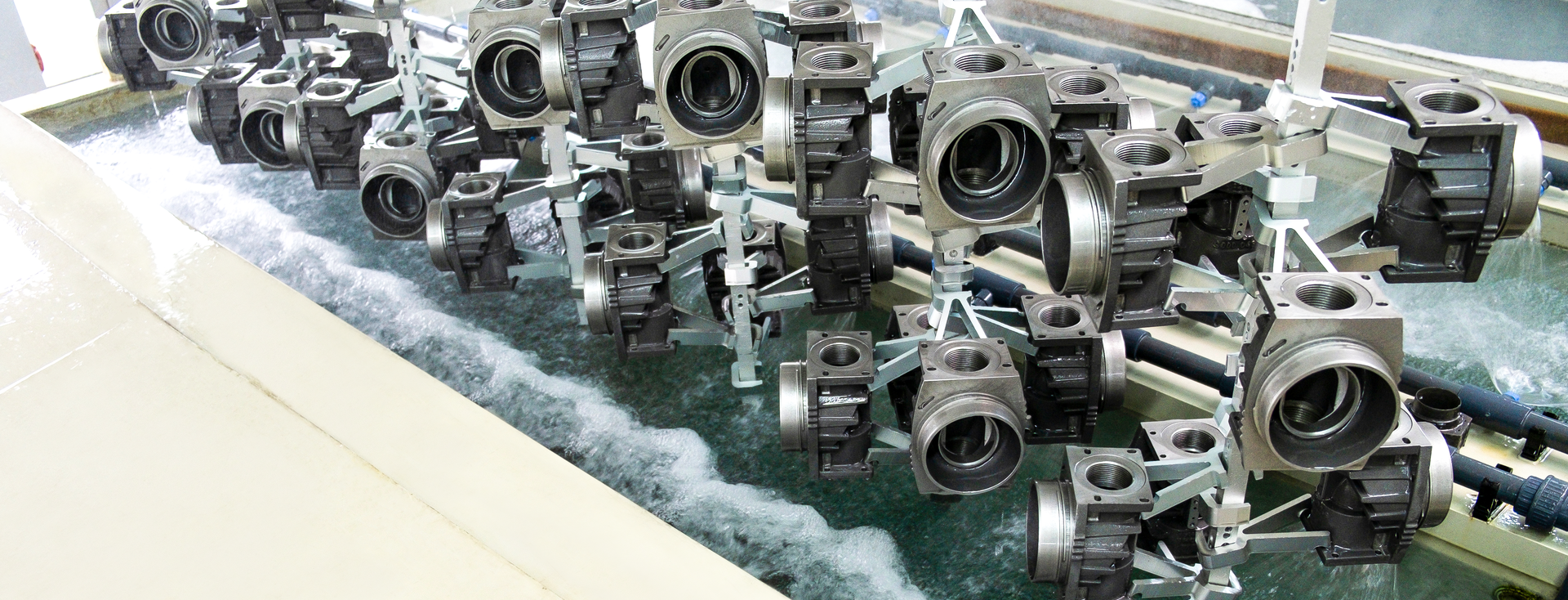 metal castings are immersed in a cleaning bath for surface treatment metal castings are immersed in a cleaning bath for surface treatment